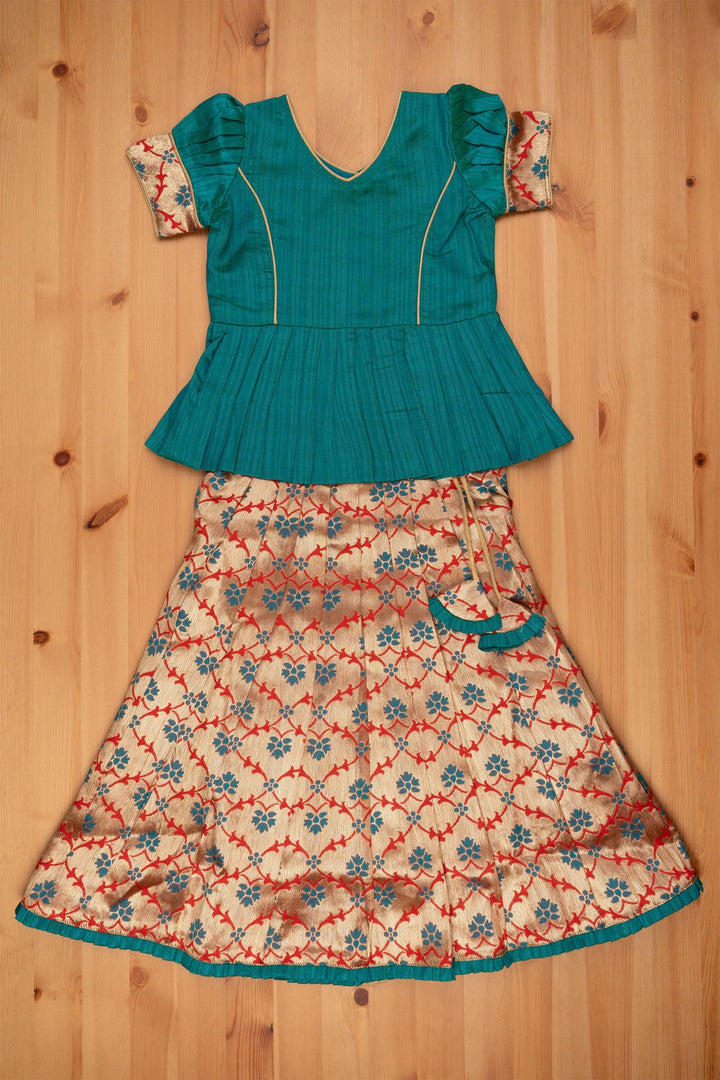 The Nesavu Pattu Pavadai Alluring Green Silk Peplum Blouse with Zari Floral Designer Pattu Pavadai: Heritage Silk Ensemble Nesavu Green Silk Blouse with Zari Floral Pattu Pavadai | Girls Silk Langa Voni | The Nesavu