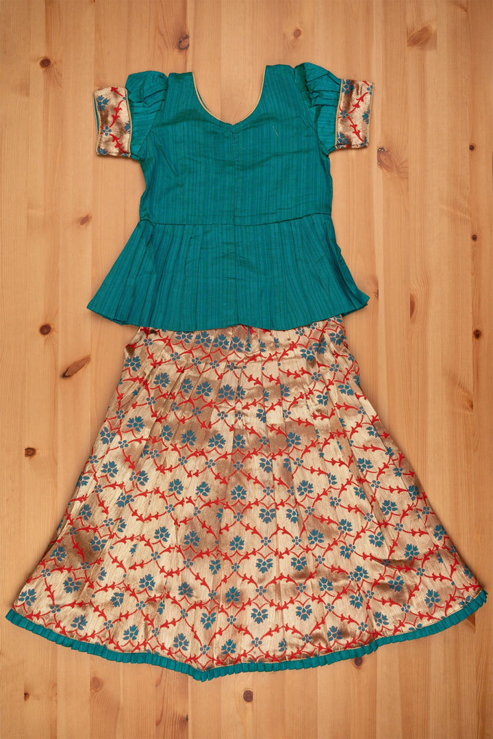 The Nesavu Pattu Pavadai Alluring Green Silk Peplum Blouse with Zari Floral Designer Pattu Pavadai: Heritage Silk Ensemble Nesavu Green Silk Blouse with Zari Floral Pattu Pavadai | Girls Silk Langa Voni | The Nesavu