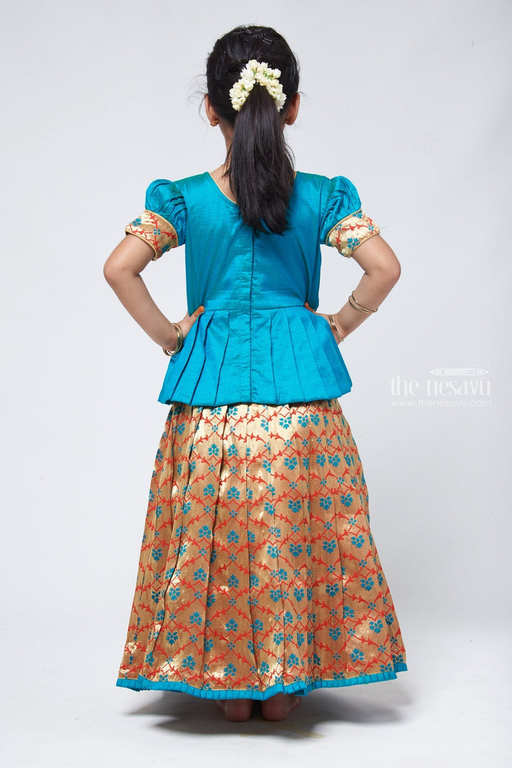 The Nesavu Pattu Pavadai Alluring Green Silk Peplum Blouse with Zari Floral Designer Pattu Pavadai: Heritage Silk Ensemble Nesavu Green Silk Blouse with Zari Floral Pattu Pavadai | Girls Silk Langa Voni | The Nesavu