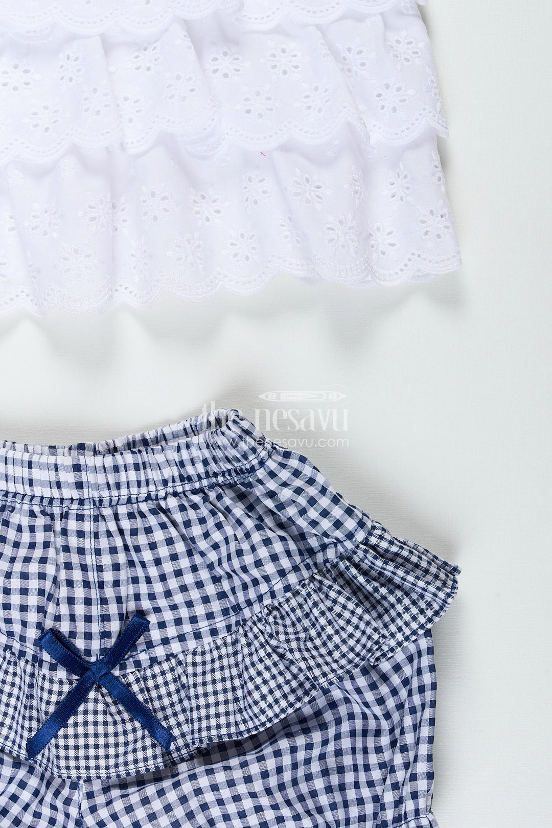 The Nesavu Baby Frocks Baby girl frock with navy gingham shorts and bow detailing Nesavu Nesavu white hakoba baby frock with navy checked bloomers