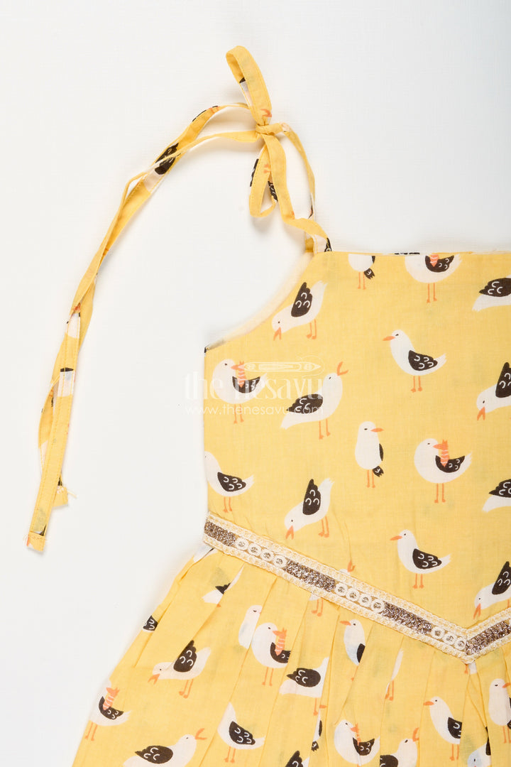 The Nesavu Tie-up Frock Yellow Tie-Up Cotton Frock for Toddler Girls with Playful Bird Print Nesavu Nesavu yellow cotton tie-up frock for toddler girls with playful bird print and pleated flare