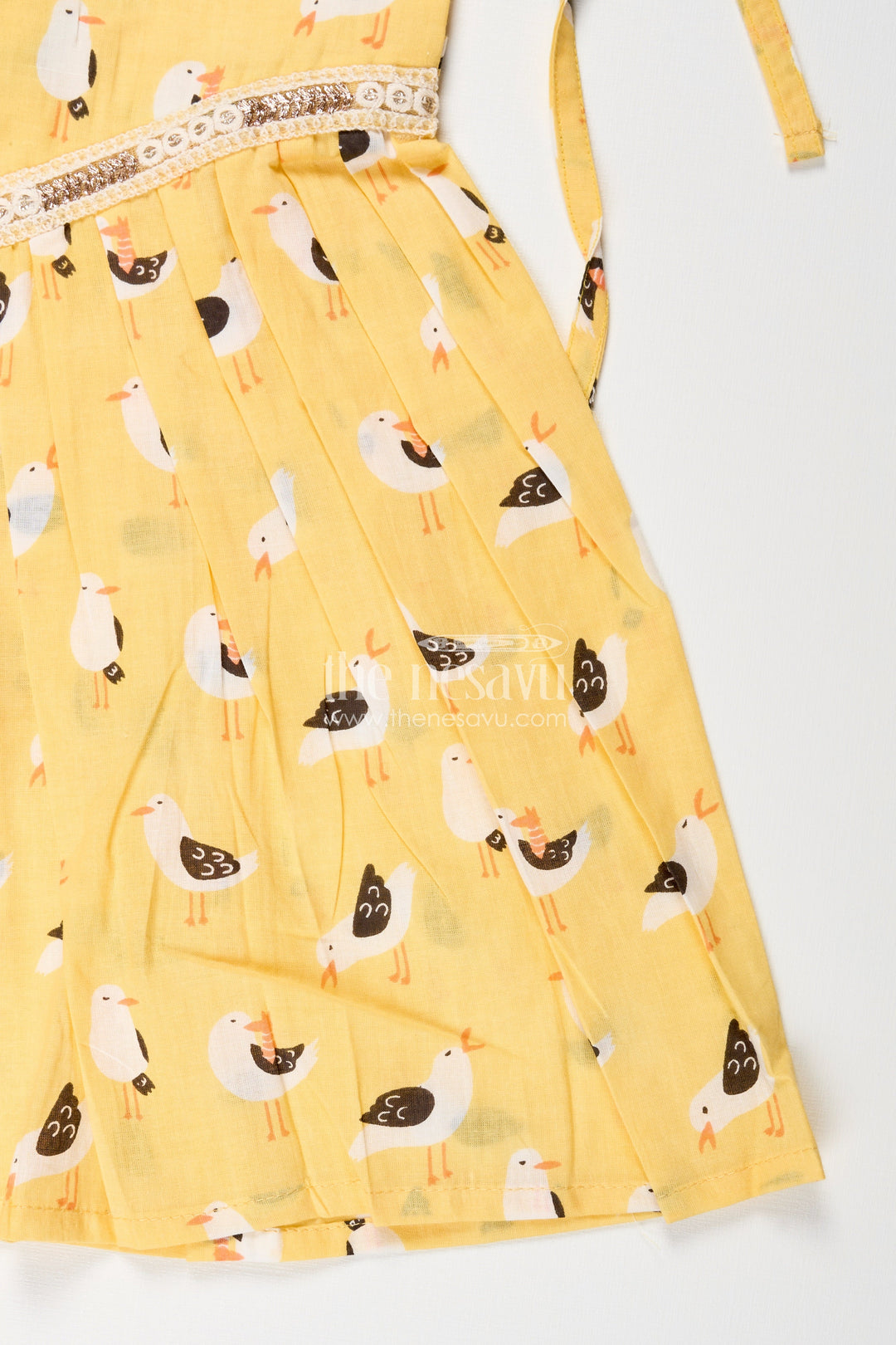 The Nesavu Tie-up Frock Yellow Tie-Up Cotton Frock for Toddler Girls with Playful Bird Print Nesavu Nesavu yellow cotton tie-up frock for toddler girls with playful bird print and pleated flare