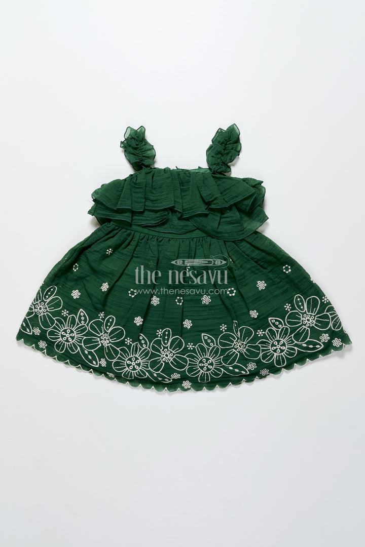 Temple visit baby frock in traditional green with soft cotton fabric and intricate floral lace accents