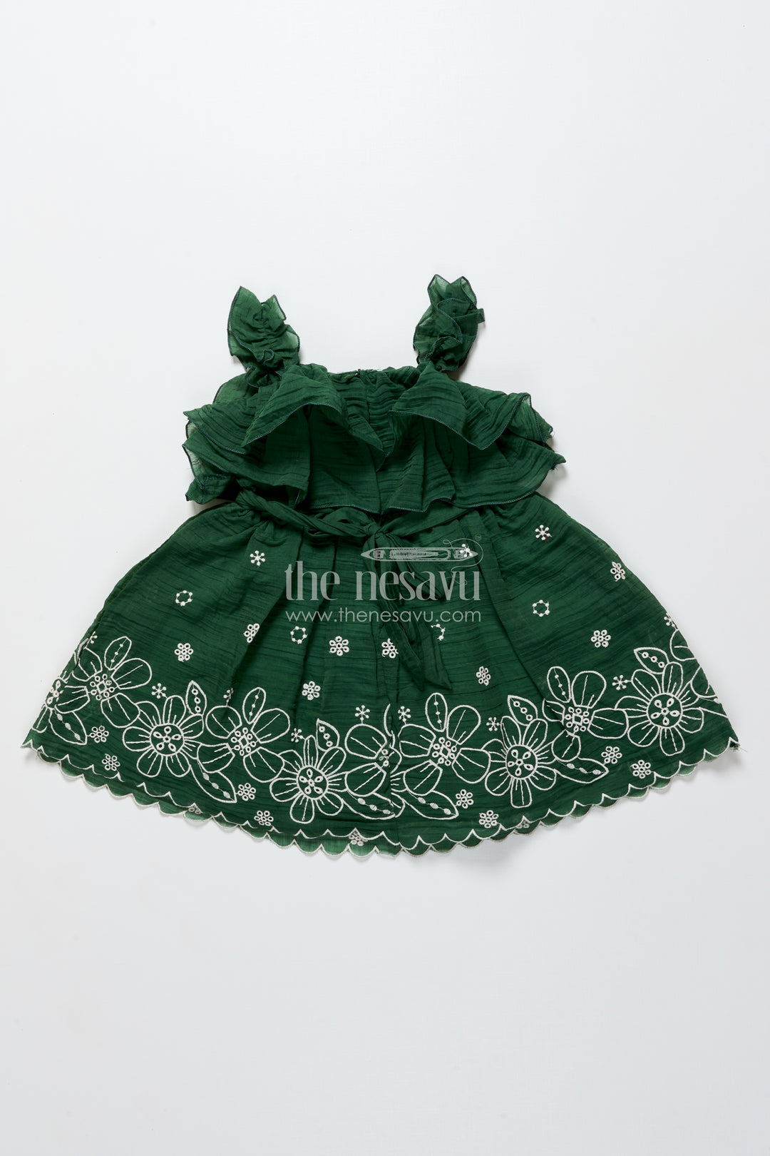 Temple visit baby frock in traditional green with soft cotton fabric and intricate floral lace accents