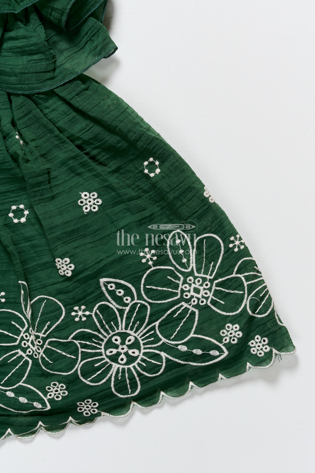 Temple visit baby frock in traditional green with soft cotton fabric and intricate floral lace accents