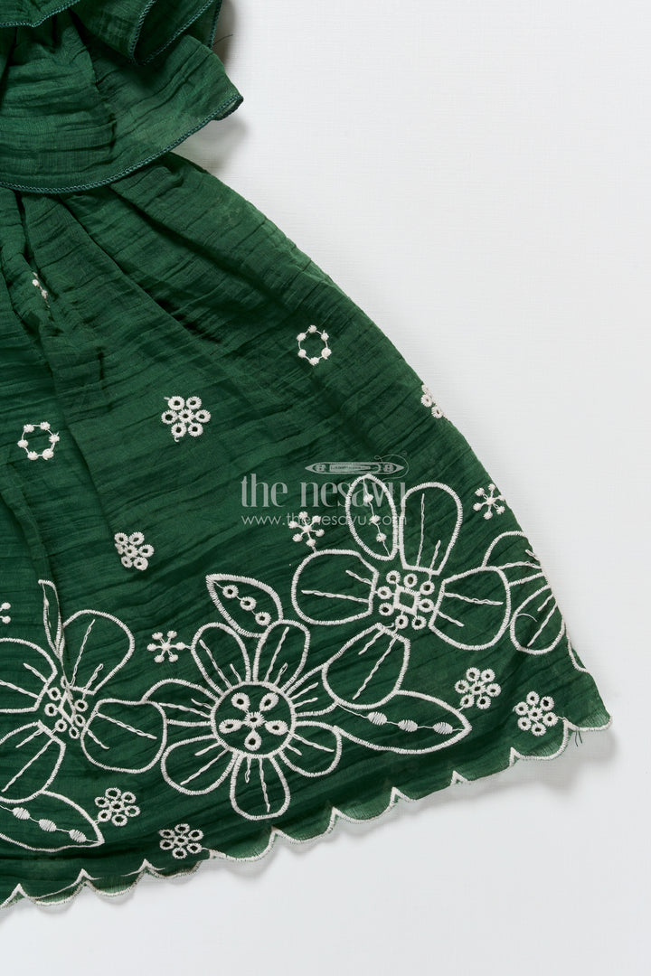Temple visit baby frock in traditional green with soft cotton fabric and intricate floral lace accents