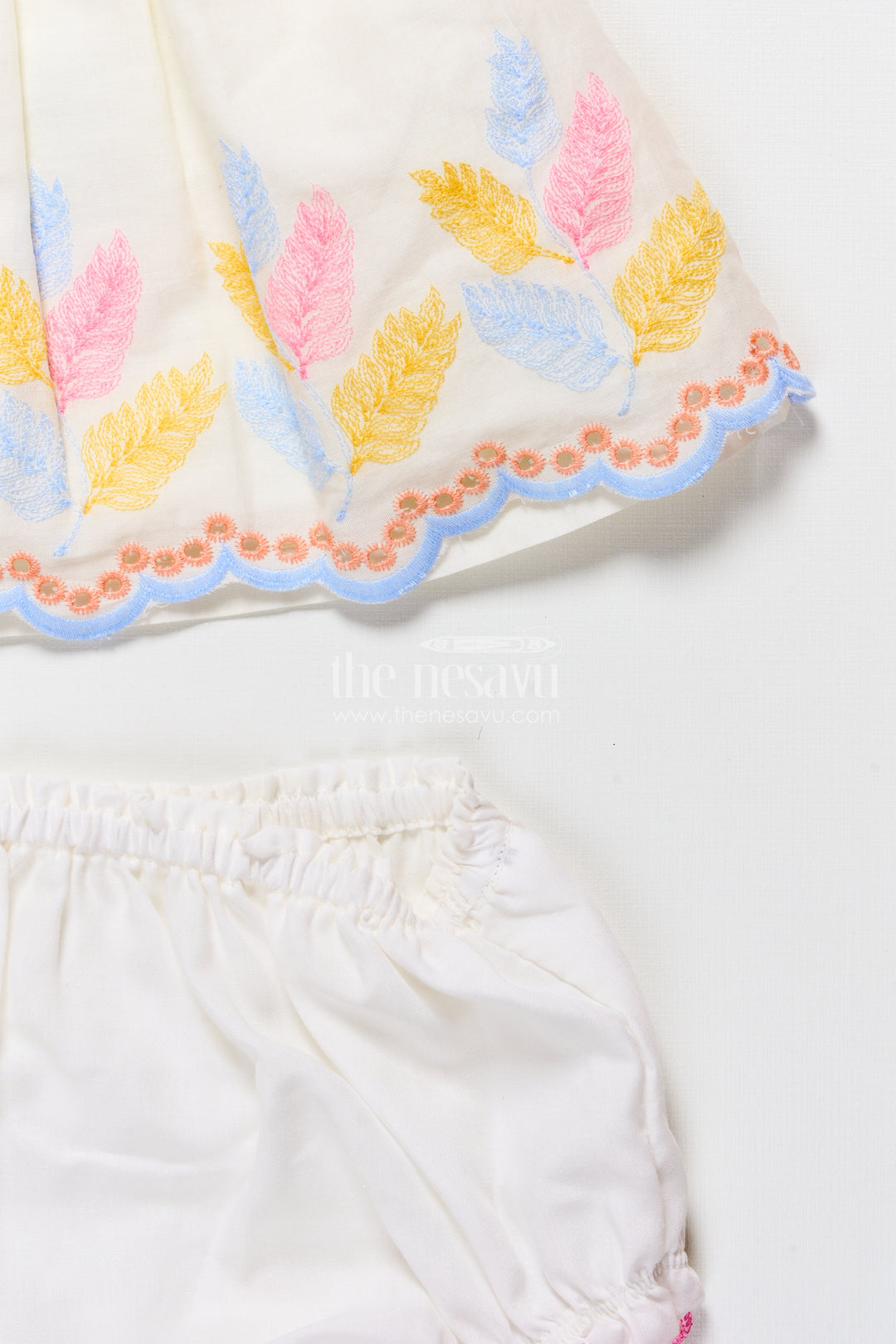 Sleeveless baby frock with floral embroidery and pastel feather design