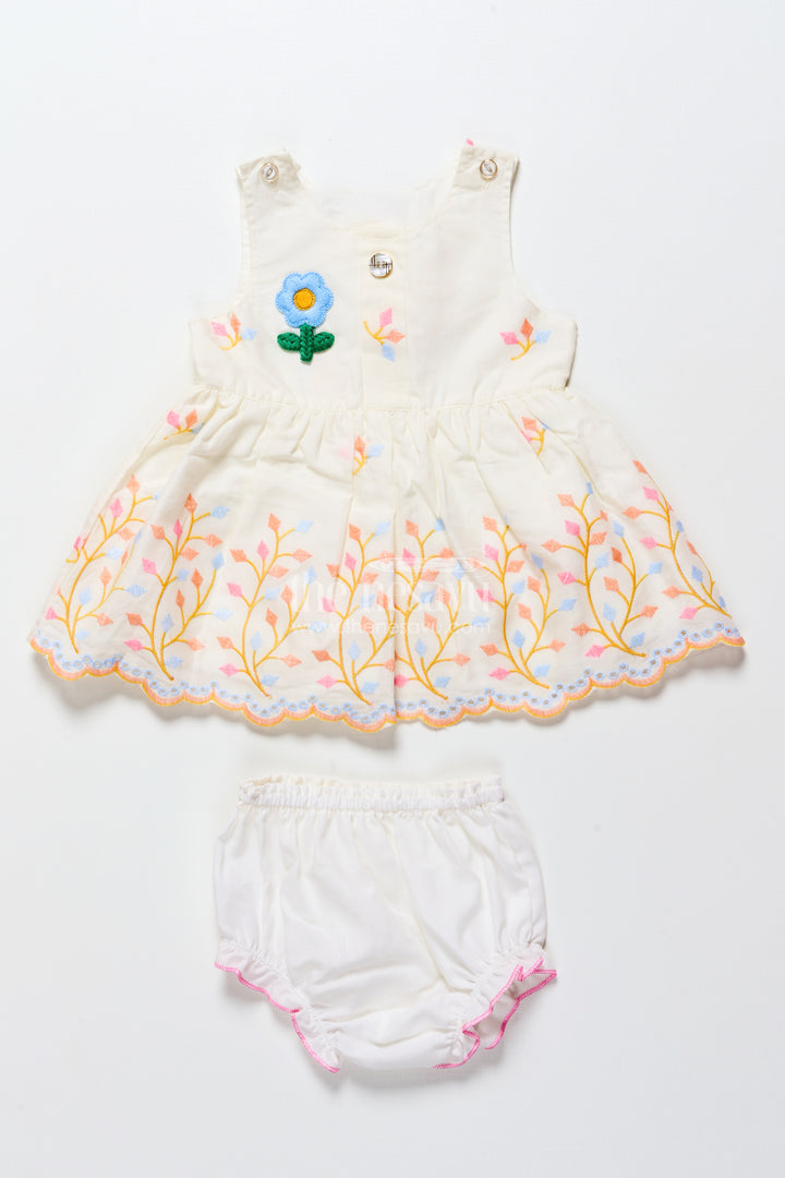 Baby frock with rainbow leaf embroidery and floral patch