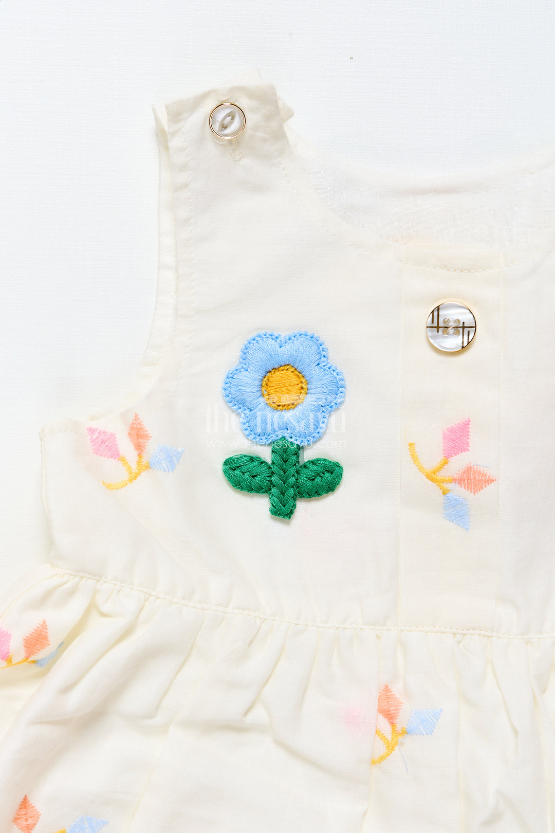 Baby frock with rainbow leaf embroidery and floral patch