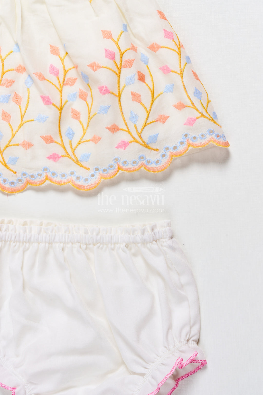 Baby frock with rainbow leaf embroidery and floral patch