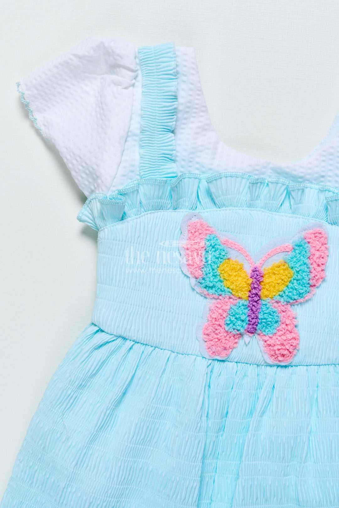 Baby frock in seersucker cotton with multicolor butterfly patch Pink