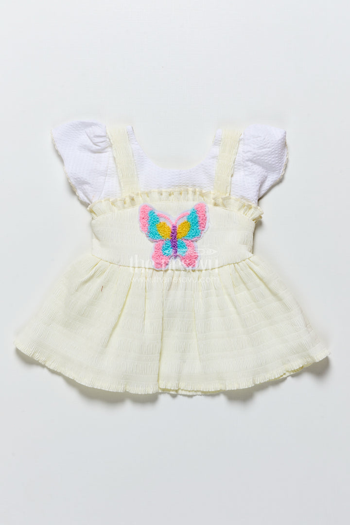 Baby frock in light blue seersucker cotton with butterfly patch