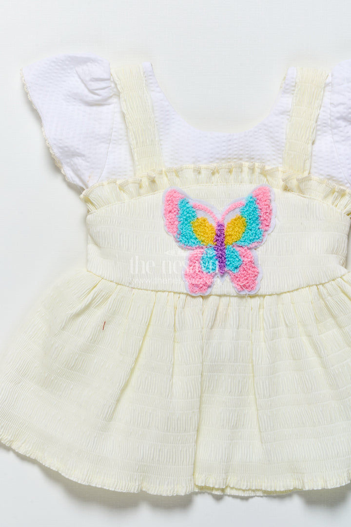 Baby frock in light blue seersucker cotton with butterfly patch