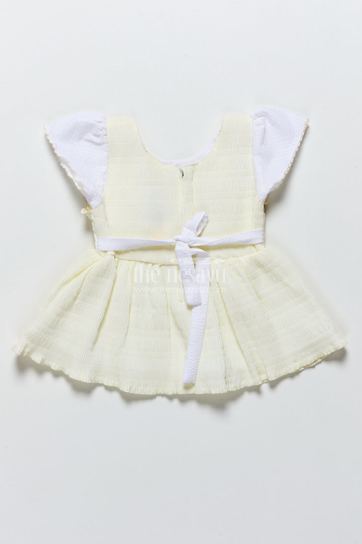 Baby frock in light blue seersucker cotton with butterfly patch