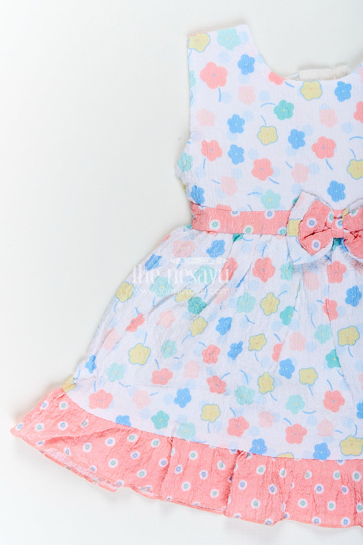 Baby girl cotton frock with pastel floral print and ruffle hem