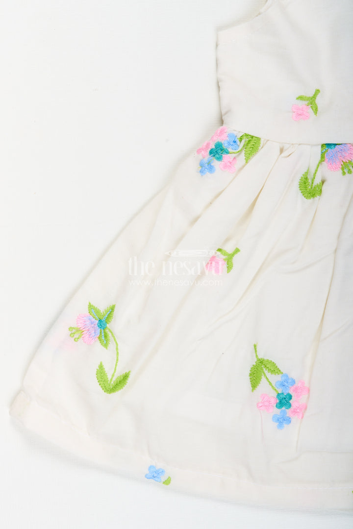 White cotton frock with floral embroidery and shoulder straps for baby girls