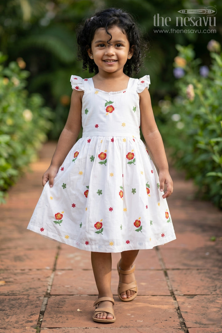 Girls White Floral Frock in Cotton Embroidery with Delicate Ruffles and Playful Design