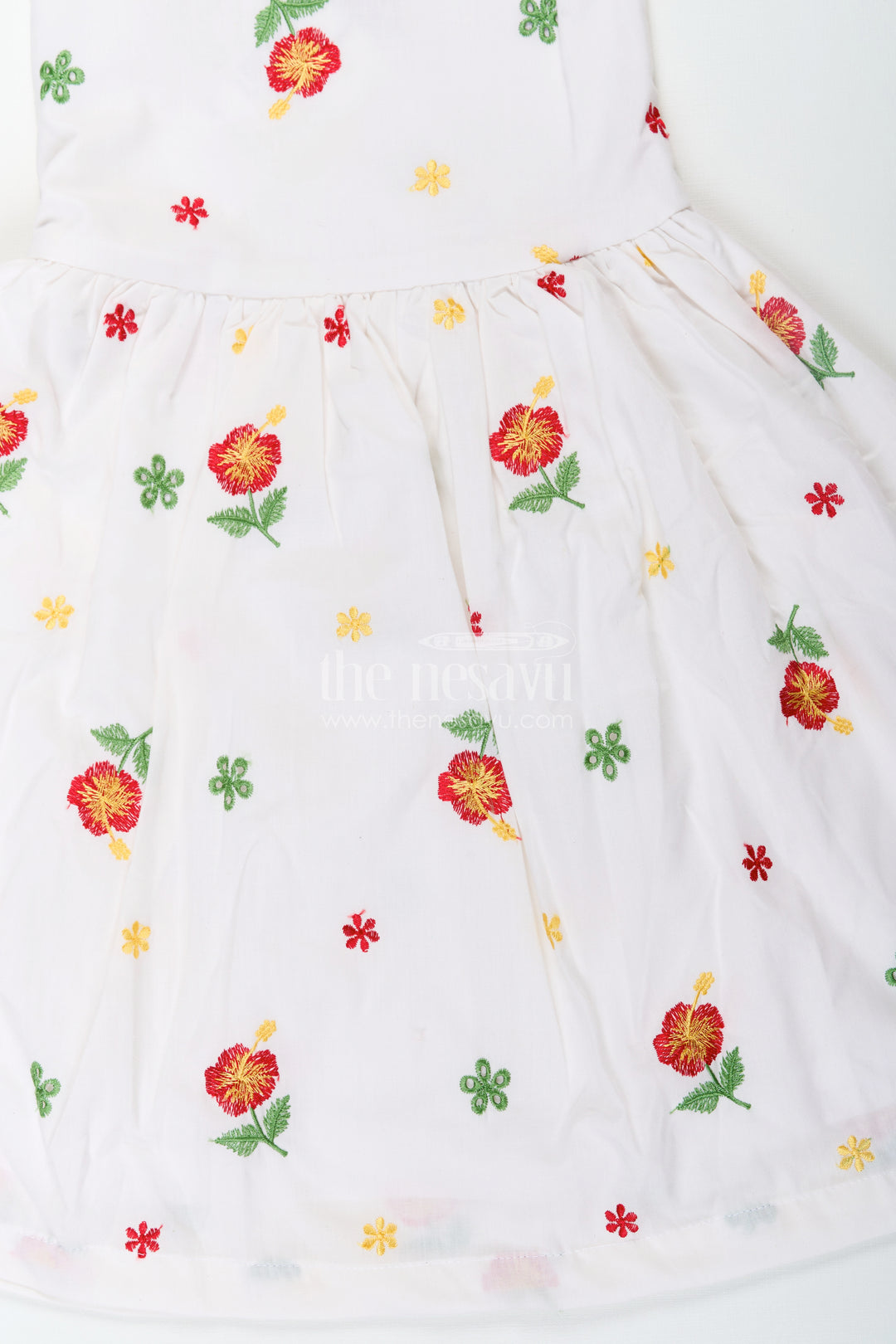 Girls White Floral Frock in Cotton Embroidery with Delicate Ruffles and Playful Design