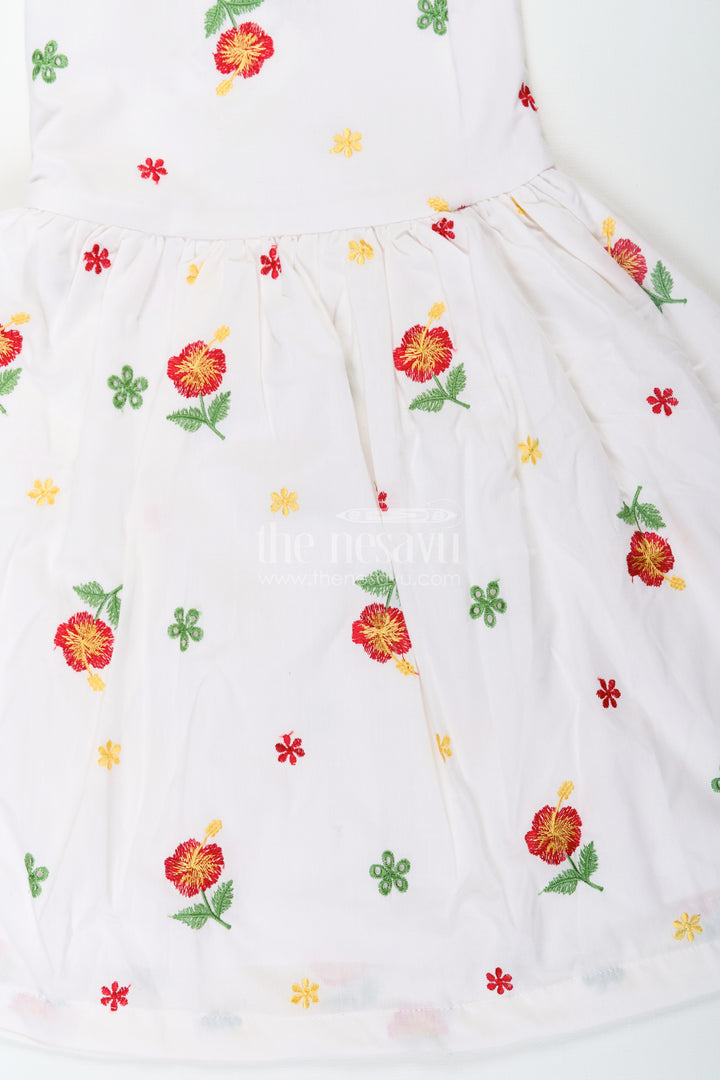 Girls White Floral Frock in Cotton Embroidery with Delicate Ruffles and Playful Design