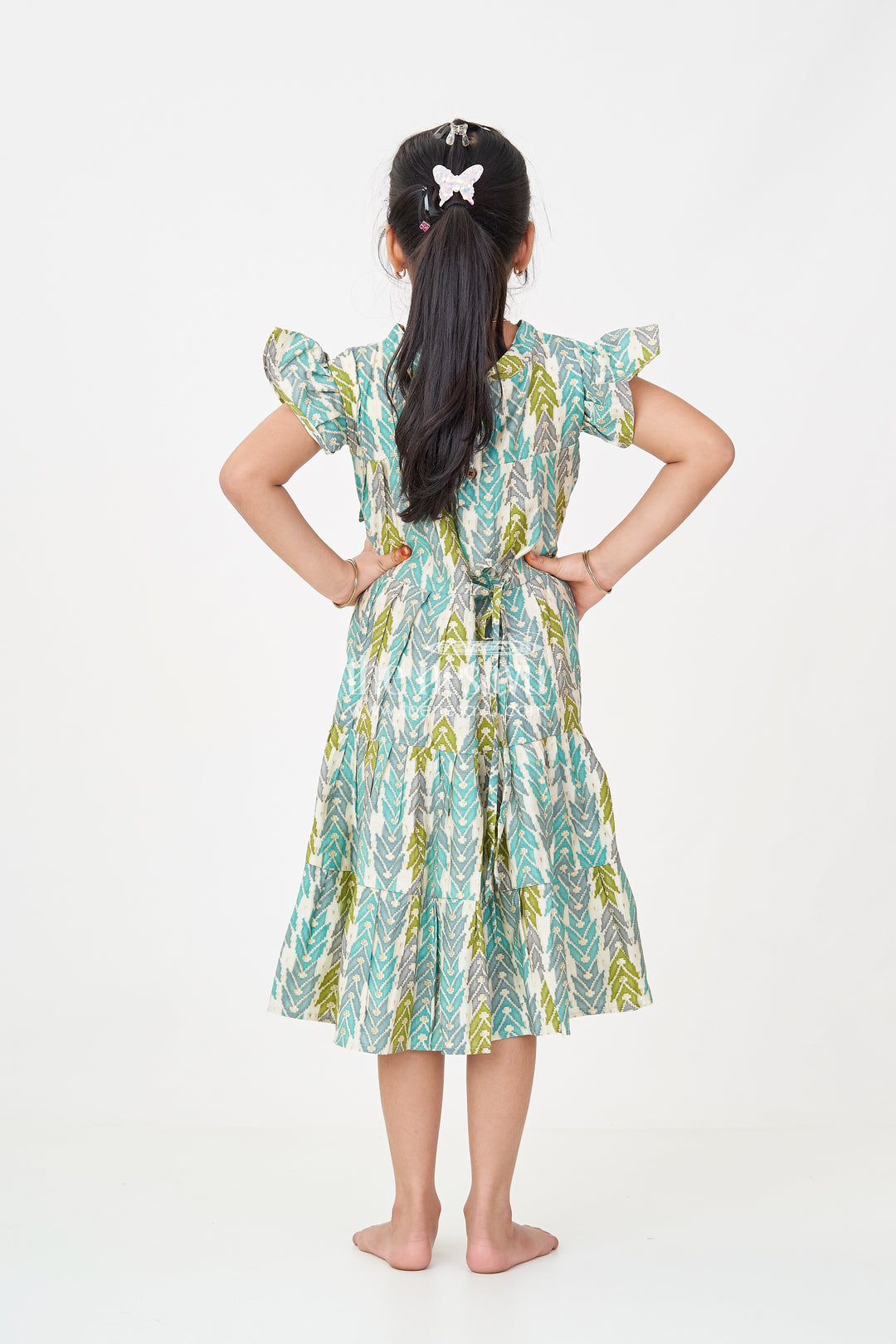 Green Colour Frock for Girls in Modal Silk with Multicolor Geometric Print and Front Bow Design