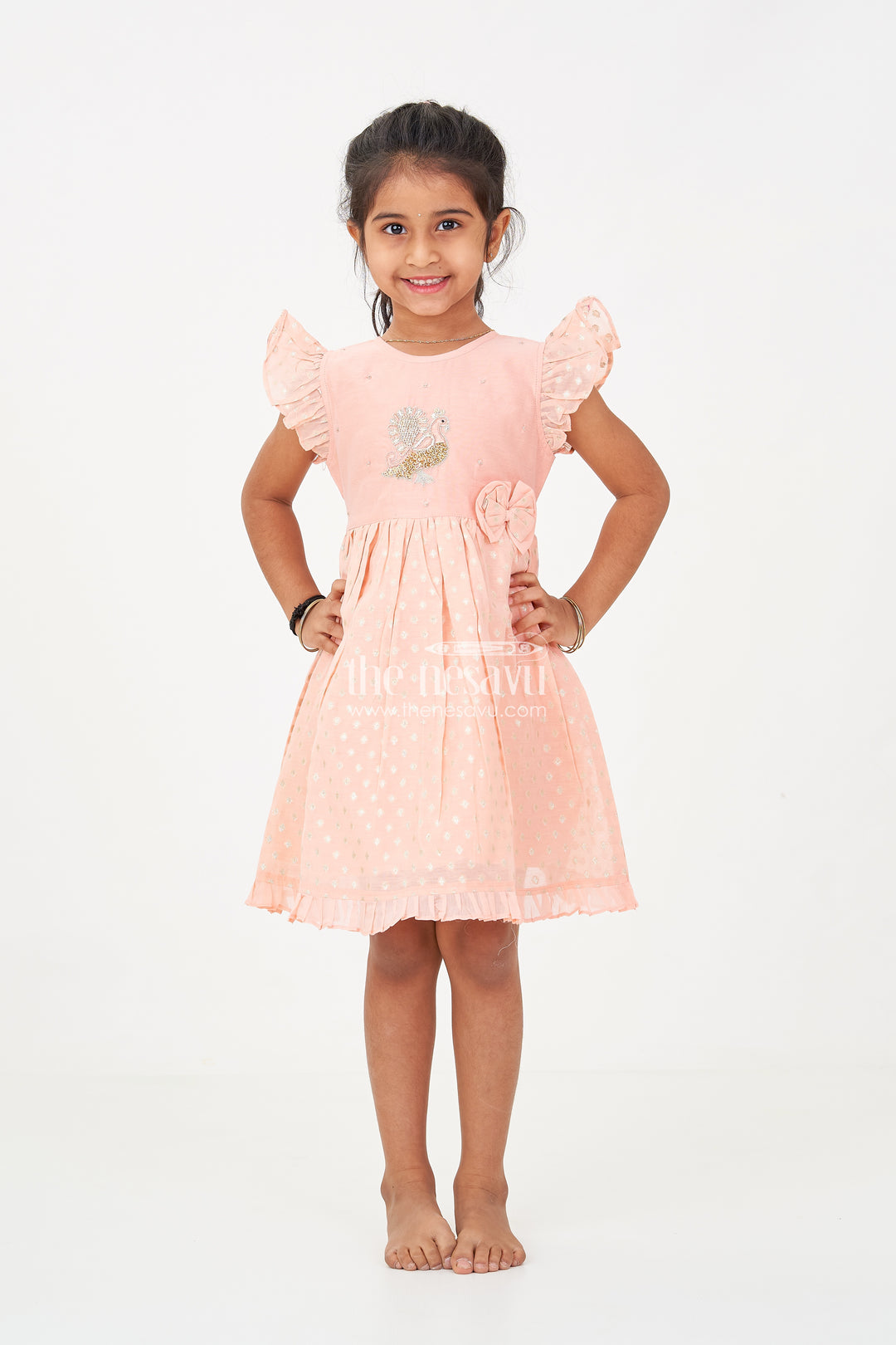 Girls dark peach colour frock in Chanderi with Thread Embroidered Peacock and Frilled Hem Design