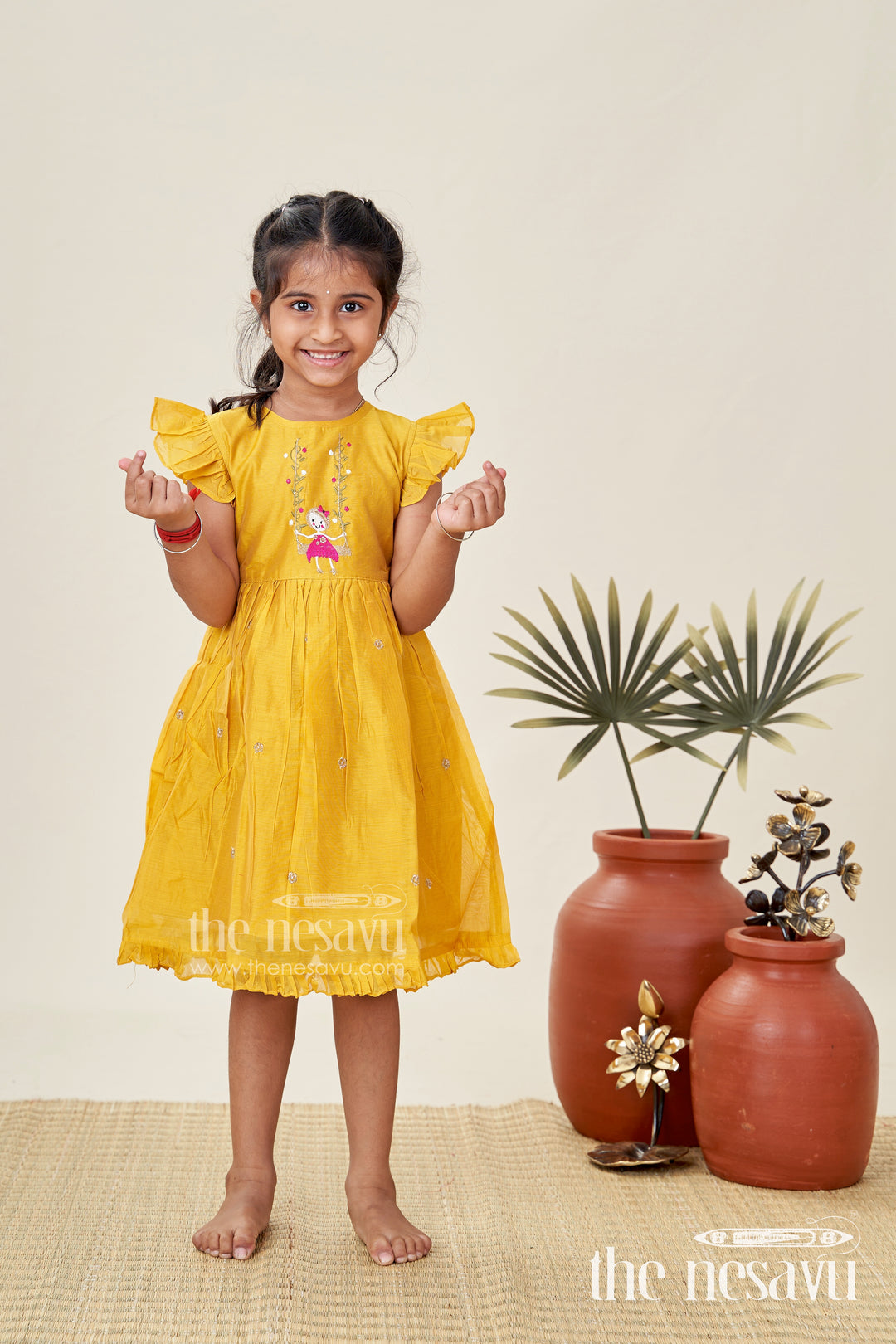 Girls Chanderi Cotton Simple Frock Design with Swing Embroidery and Frill Sleeves in Honey Yellow