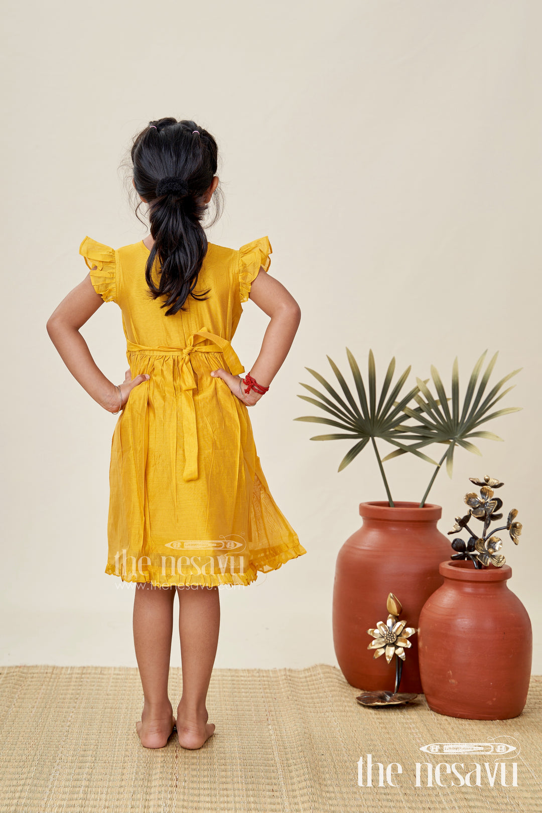 Girls Chanderi Cotton Simple Frock Design with Swing Embroidery and Frill Sleeves in Honey Yellow