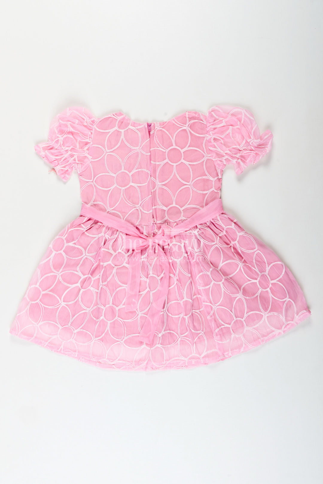 Girls pink embroidered organza frock with floral brooch for festive wear