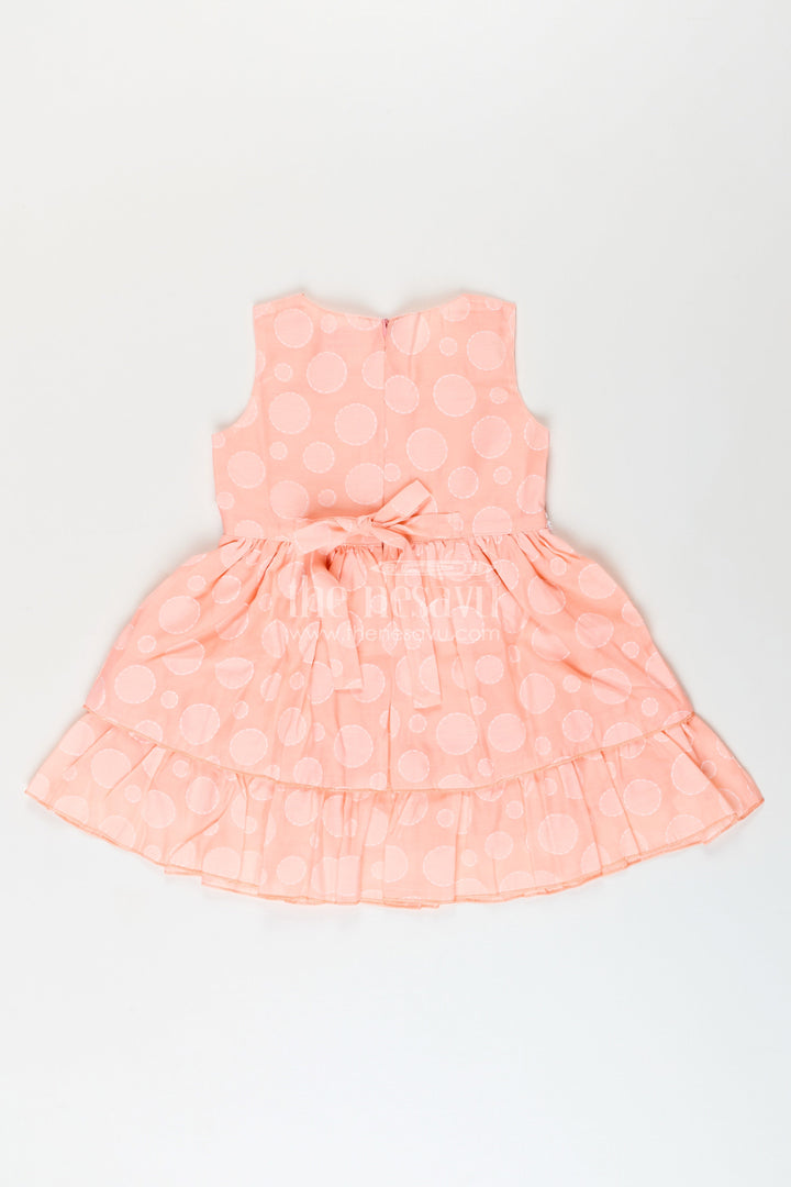 Girls peach georgette frock with polka dots for birthday and festive wear