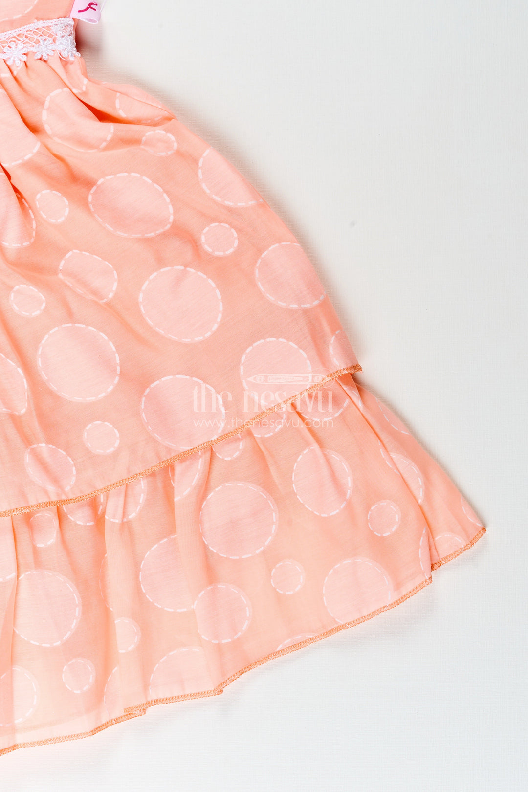 Girls peach georgette frock with polka dots for birthday and festive wear