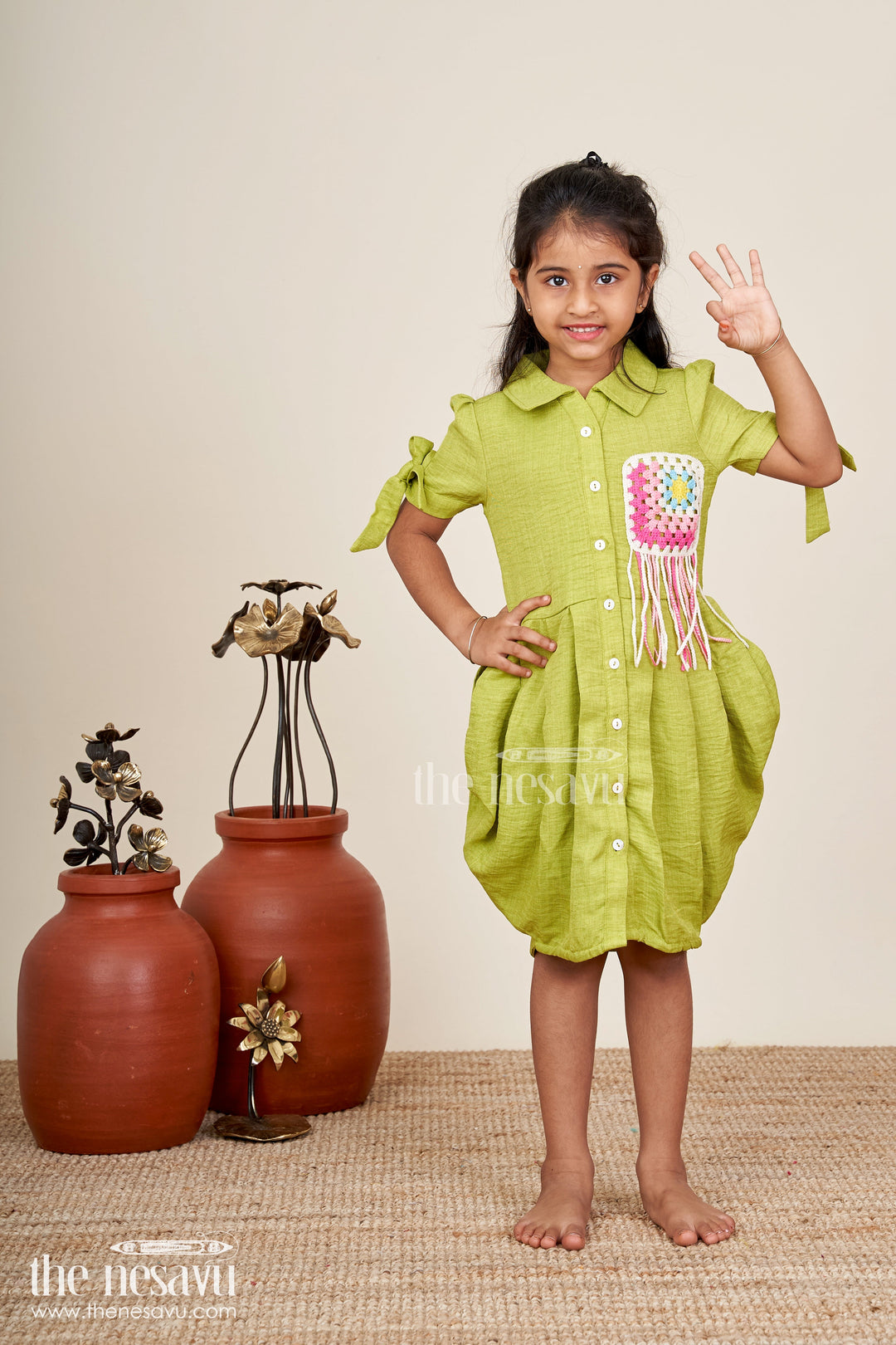 Green girls cotton frock with crochet patch and tie-up sleeves