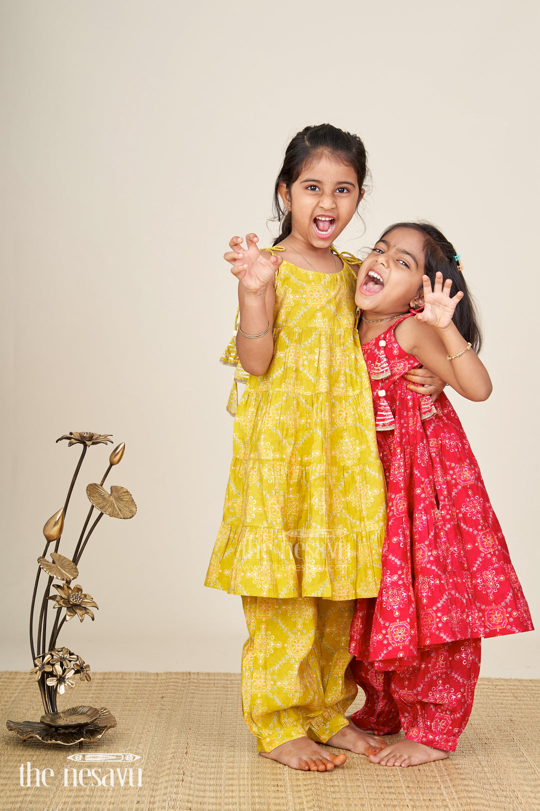 Girls yellow sharara set with printed tiered kurti for festive dressing