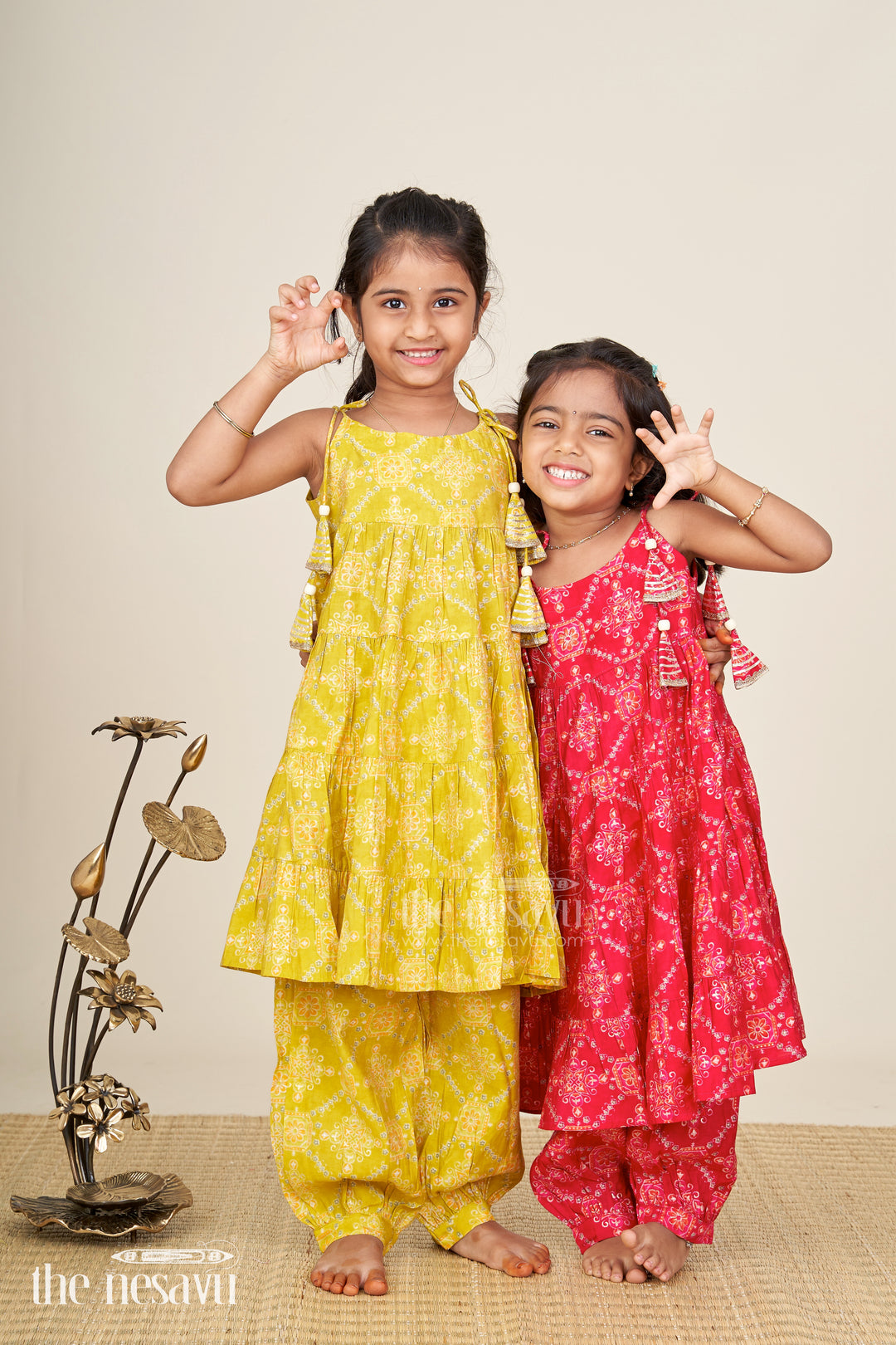 Girls yellow sharara set with printed tiered kurti for festive dressing