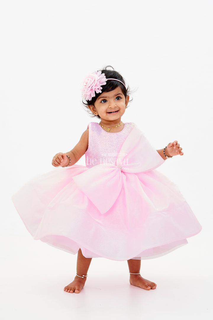 Baby Girls Fancy Frock in Pink Shimmer Fabric with Oversized Bow and Flared Silhouette