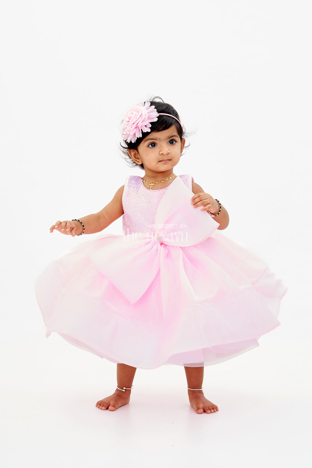 Baby Girls Fancy Frock in Pink Shimmer Fabric with Oversized Bow and Flared Silhouette