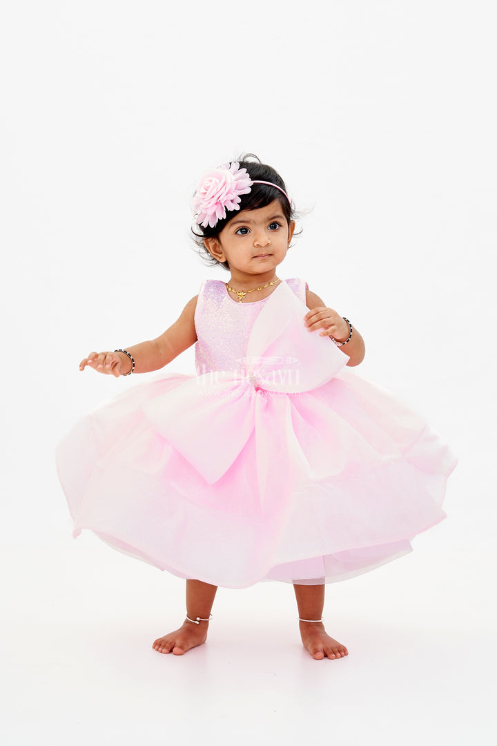 Baby Girls Fancy Frock in Pink Shimmer Fabric with Oversized Bow and Flared Silhouette
