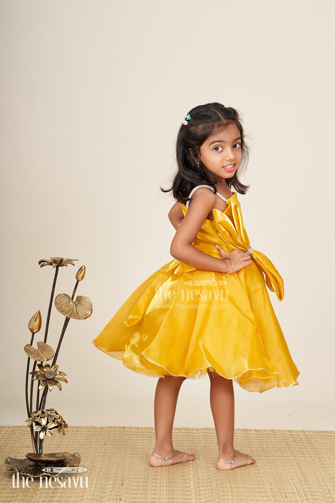 Girls golden satin party frock with bow detail
