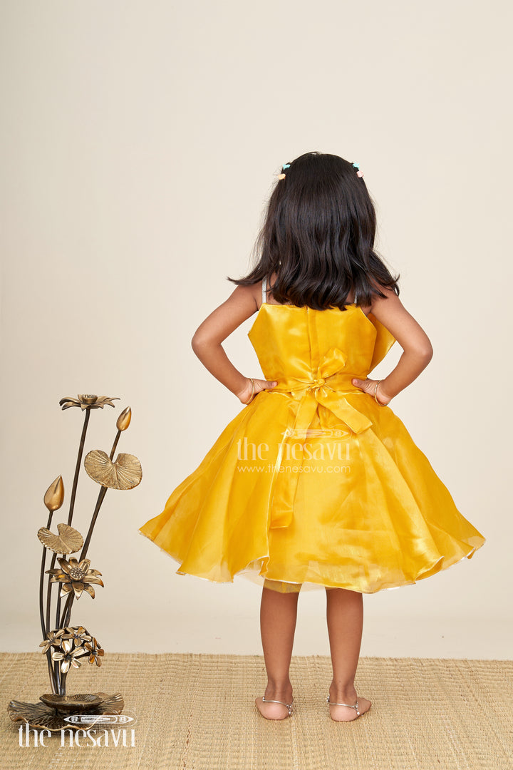 Girls golden satin party frock with bow detail