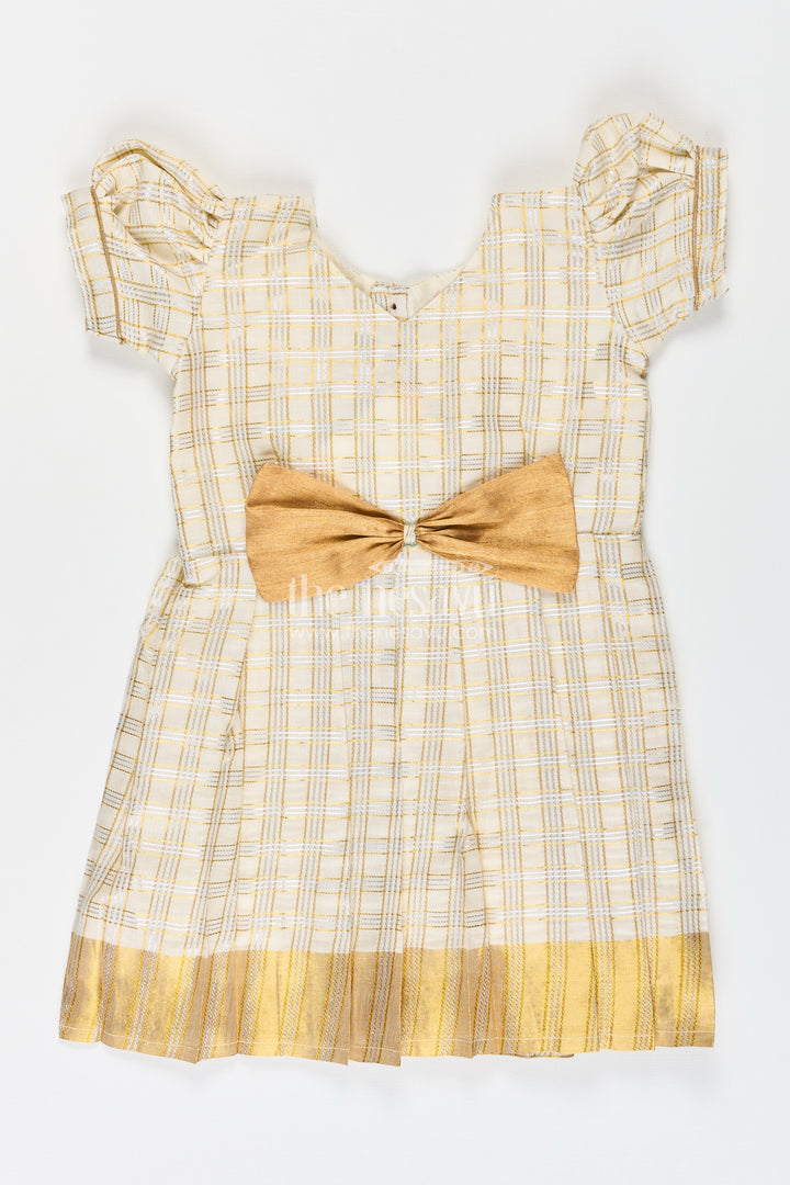 Girls Pattu Frock in Beige Tissue with Gold Bow and Checked Design for Festive Elegance