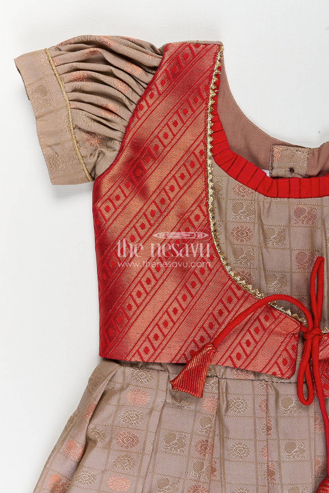 Girls Kanchivaram Soft Silk Frocks with Beige Body Red Puff Sleeves and Rich Zari Woven Hemline