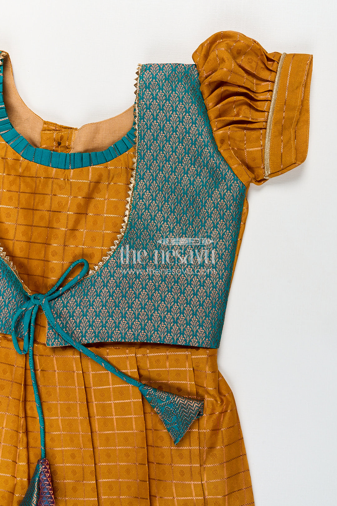 Girls Kanchivaram Orange Silk Frocks with Puff Sleeves Green Zari Overlay and Traditional Woven Border