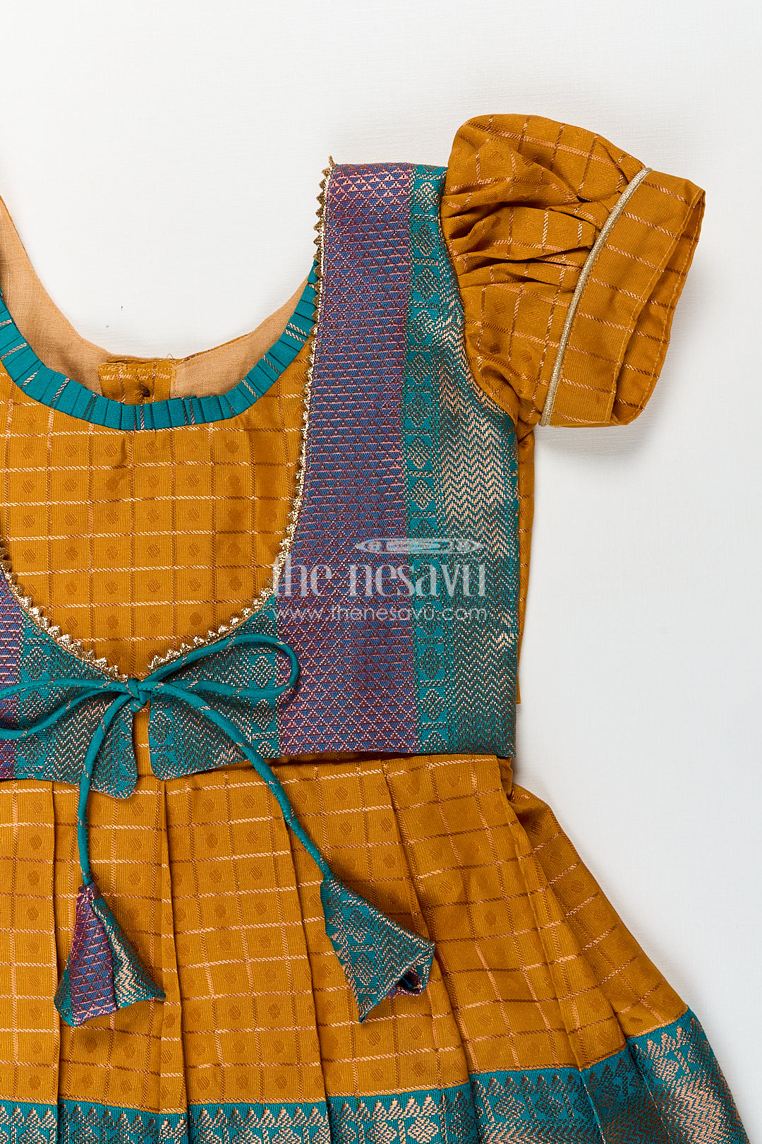 Girls Kanchivaram Orange Silk Frocks with Puff Sleeves Green Zari Overlay and Traditional Woven Border