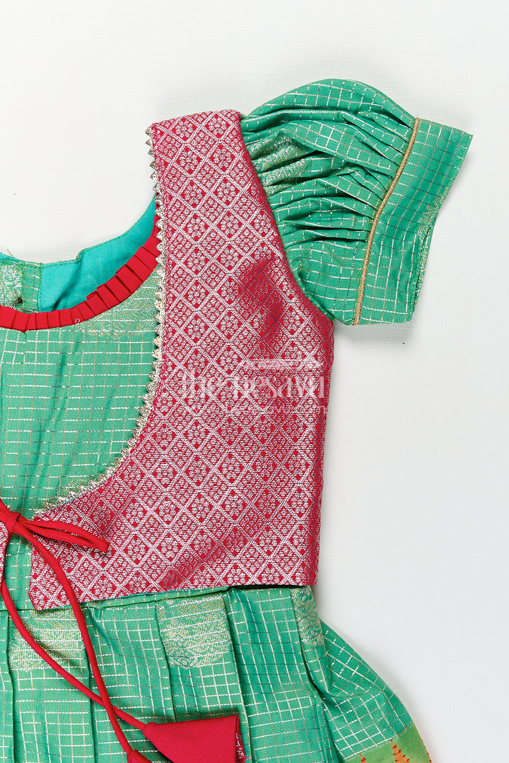 Girls Silk Material Frock Design in Semi Kanchivaram with Green Pleated Skirt and Pink Brocade Yoke