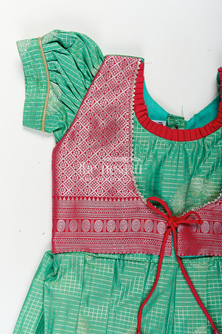 Girls Silk Material Frock Design in Semi Kanchivaram with Green Pleated Skirt and Pink Brocade Yoke