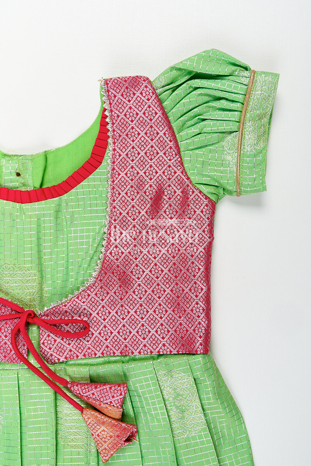 Girls Silky Long Frock in Semi Kanchivaram with Rich Pink Zari Pleats and Green Patterned Bodice