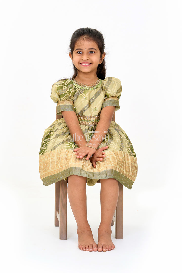 Girls Fancy Frock in Green Tissue Silk with Floral Embellishments and Short Pleated Skirt