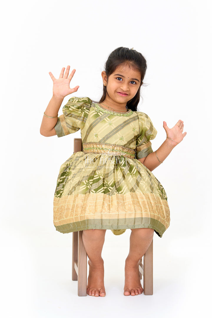 Girls Fancy Frock in Green Tissue Silk with Floral Embellishments and Short Pleated Skirt