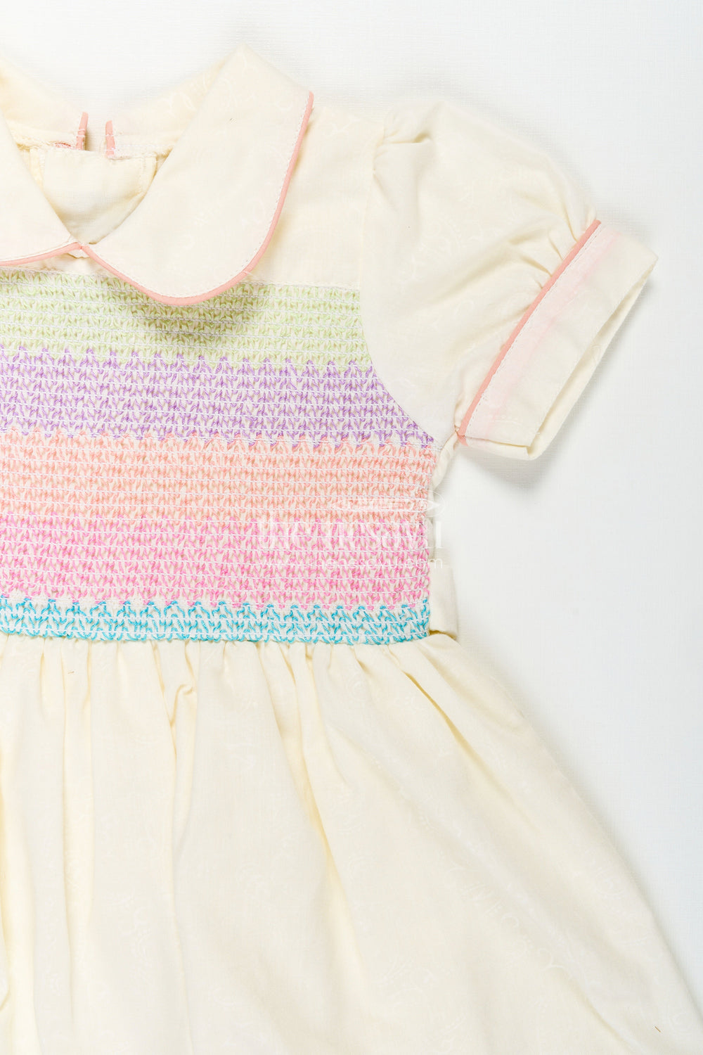 The Nesavu Girls Cotton Frock Archive -Girls Short Frock White Colour with Smocked Rainbow Yoke and Peter Pan Collar in Soft Cotton Blend Nesavu Nesavu Girls Short Frock White Colour Rainbow Smocked Yoke Peter Pan Collar