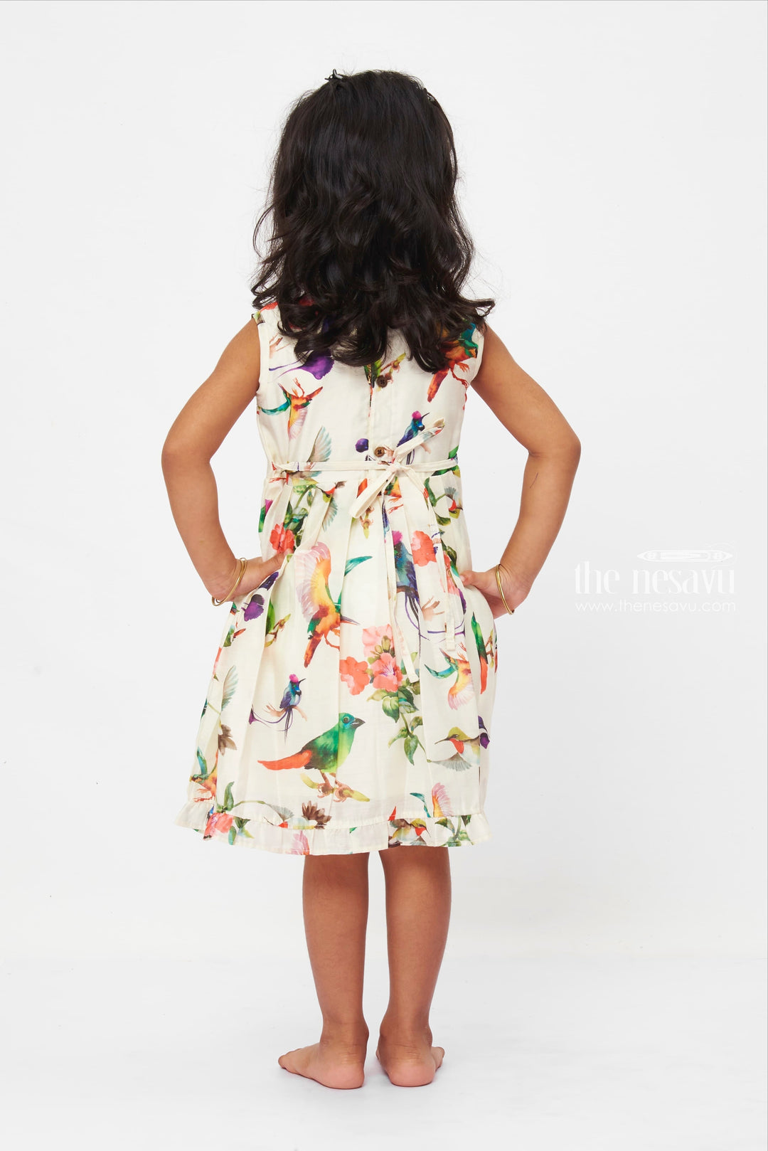 The Nesavu Girls Cotton Frock Avian Paradise Sleeveless Dress: Vibrant Bird & Floral Print Frock for Girls Nesavu Colorful Bird Print Girls Dress | Floral Sleeveless Summer Frock | Playful Ruffle Hem | The Nesavu