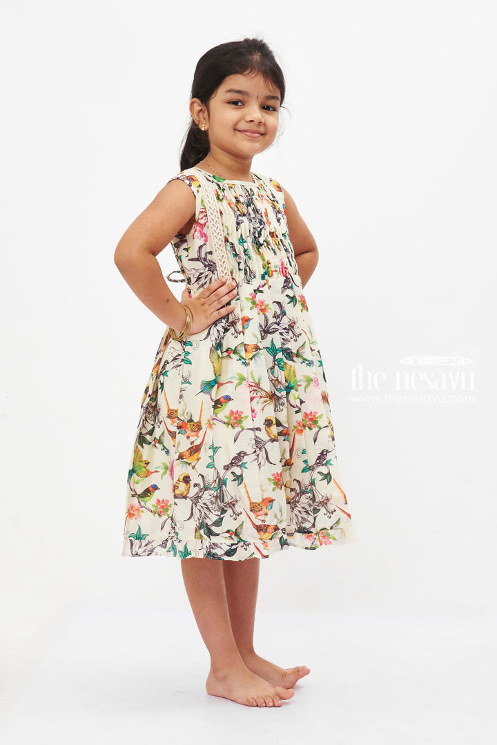 The Nesavu Girls Cotton Frock Aviary Elegance Summer Dress: Girls' Sleeveless Frock with Vivid Bird Print Nesavu Girls White Tropical Bird Print Dress | Sleeveless Lace Trim Frock | Summer Party Outfit | The Nesavu